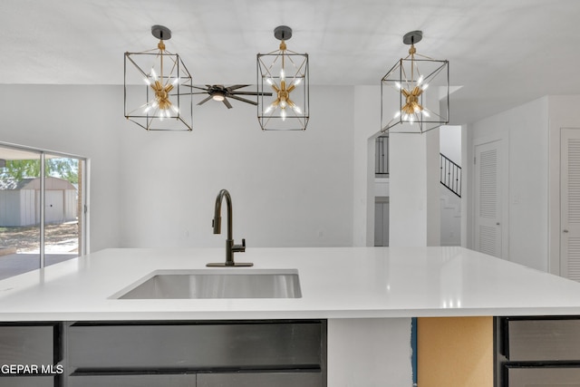 1460 Backus St, El Paso, TX 79925 - kitchen with a sink, a chandelier, pendant lighting, light countertops, and an island with sink