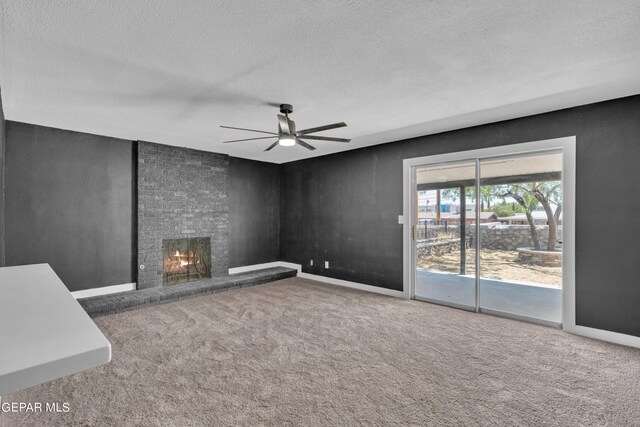 1460 Backus St, El Paso, TX 79925 - unfurnished living room featuring ceiling fan, a large fireplace, carpet flooring, a textured ceiling, and baseboards