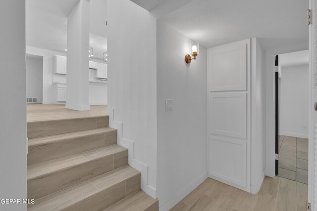 1460 Backus St, El Paso, TX 79925 - stairs featuring baseboards and wood finished floors