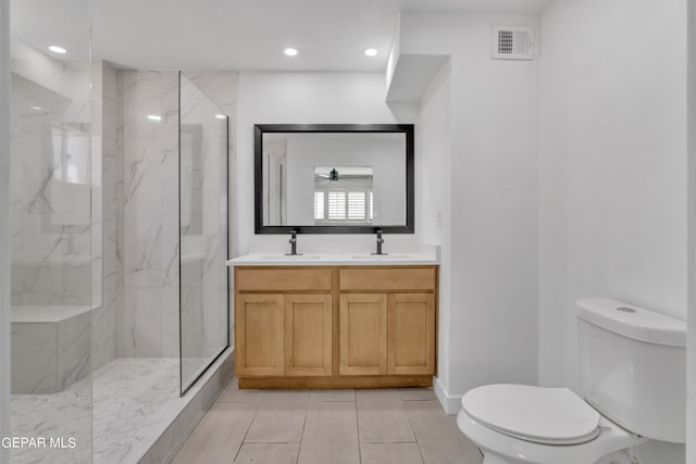 1460 Backus St, El Paso, TX 79925 - full bath featuring toilet, a marble finish shower, recessed lighting, double vanity, and tile patterned floors