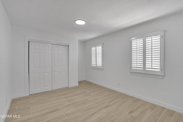1460 Backus St, El Paso, TX 79925 - unfurnished bedroom featuring light wood-style floors, baseboards, and a closet