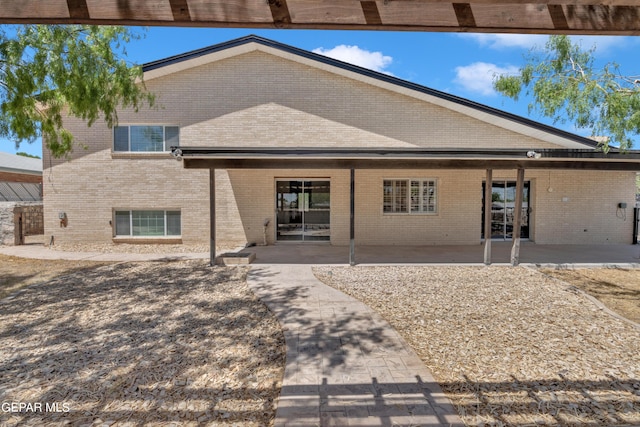 1460 Backus St, El Paso, TX 79925 - back of property featuring brick siding and a patio area