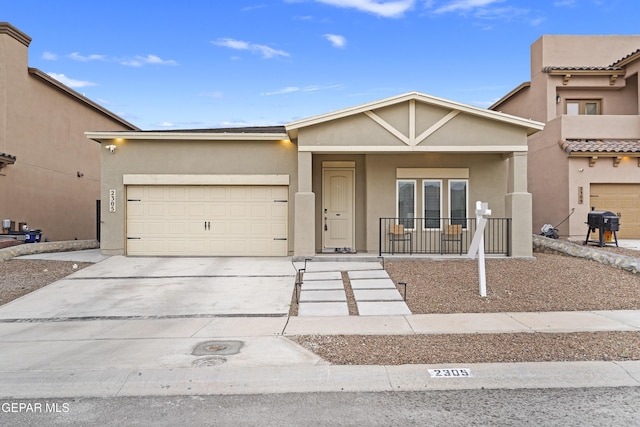 2305 Enchanted Quail, El Paso, TX 79911 - view of front facade with stucco siding, a garage, concrete driveway, and covered porch