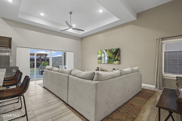 2305 Enchanted Quail, El Paso, TX 79911 - living room with a ceiling fan, recessed lighting, a raised ceiling, and light wood-style floors