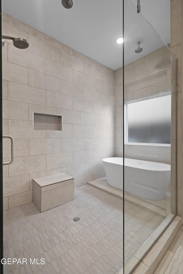 2305 Enchanted Quail, El Paso, TX 79911 - bathroom featuring a shower stall, a freestanding bath, tile patterned floors, and tile walls