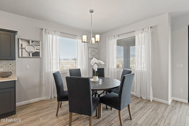 912 Pettus Pl, El Paso, TX 79928 - dining space featuring a chandelier, light wood-style flooring, and baseboards