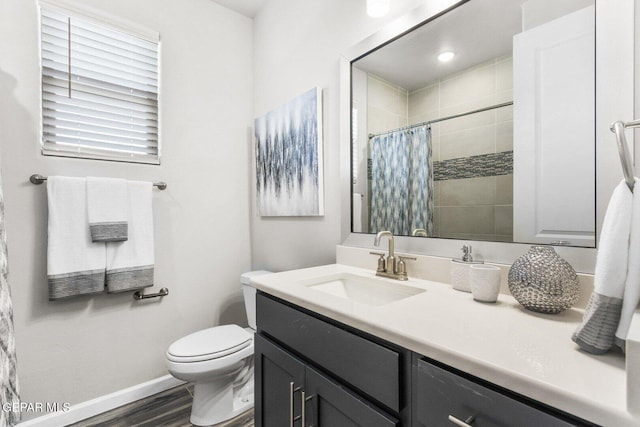 912 Pettus Pl, El Paso, TX 79928 - full bathroom with vanity, toilet, wood finished floors, baseboards, and a tile shower