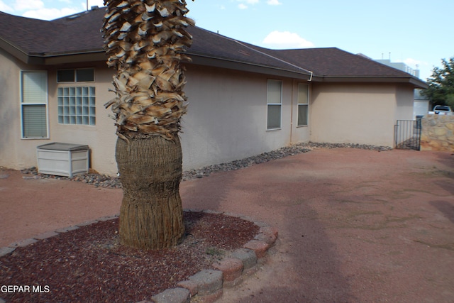 1429 Jettie Ray Way, El Paso, TX 79936 - view of side of property with a shingled roof and stucco siding