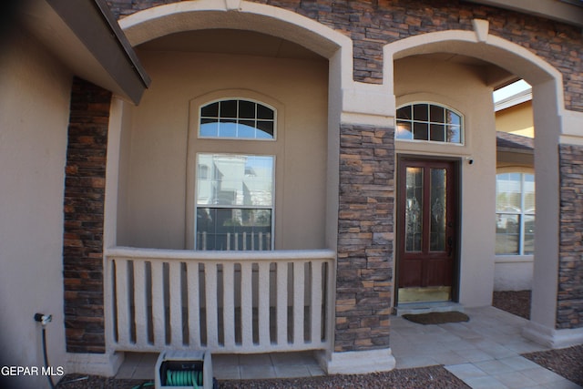 1429 Jettie Ray Way, El Paso, TX 79936 - doorway to property with stone siding, a porch, and stucco siding