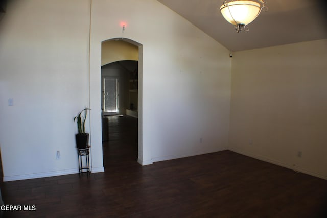 1429 Jettie Ray Way, El Paso, TX 79936 - empty room with arched walkways, wood finished floors, baseboards, and vaulted ceiling