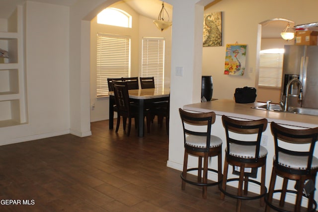 1429 Jettie Ray Way, El Paso, TX 79936 - dining space featuring arched walkways and dark wood-type flooring