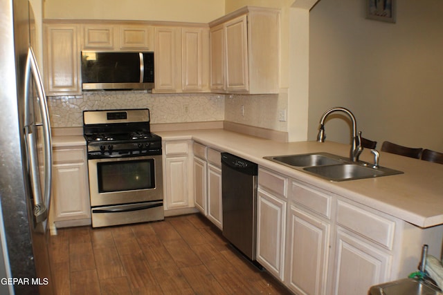 1429 Jettie Ray Way, El Paso, TX 79936 - kitchen with appliances with stainless steel finishes, a sink, decorative backsplash, and dark wood-style flooring