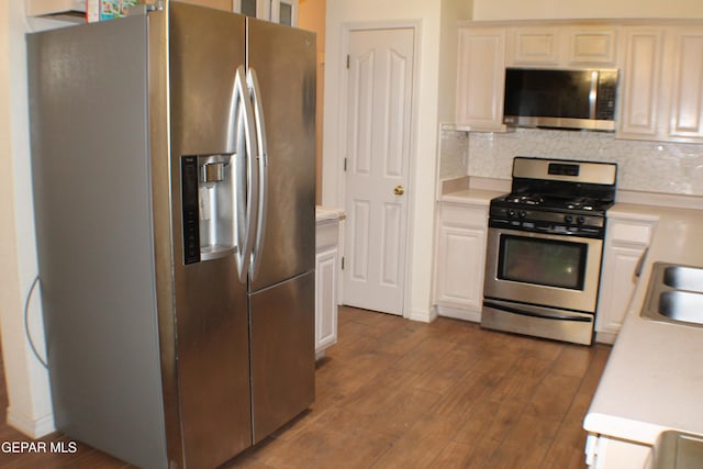 1429 Jettie Ray Way, El Paso, TX 79936 - kitchen featuring stainless steel appliances, light countertops, dark wood-type flooring, backsplash, and white cabinets