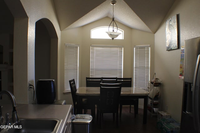 1429 Jettie Ray Way, El Paso, TX 79936 - dining area with lofted ceiling, wood finished floors, and arched walkways