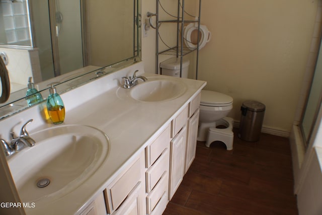 1429 Jettie Ray Way, El Paso, TX 79936 - bathroom featuring toilet, an enclosed shower, wood finished floors, double vanity, and a tub to relax in