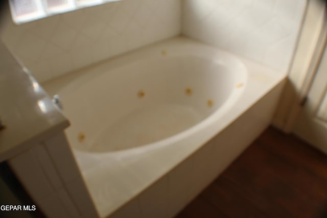 1429 Jettie Ray Way, El Paso, TX 79936 - bathroom featuring a tub with jets and wood finished floors