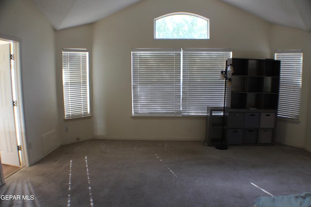 1429 Jettie Ray Way, El Paso, TX 79936 - unfurnished living room with lofted ceiling, carpet, an office area, and baseboards