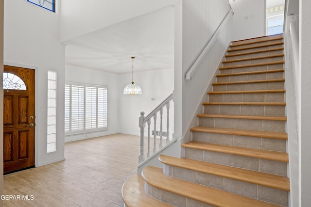 908 Via De La Paz Dr, El Paso, TX 79912 - entrance foyer with stairway, a towering ceiling, and wood finished floors