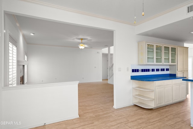 908 Via De La Paz Dr, El Paso, TX 79912 - kitchen with open shelves, crown molding, a ceiling fan, glass insert cabinets, and baseboards
