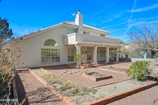 908 Via De La Paz Dr, El Paso, TX 79912 - back of property with a chimney, stucco siding, a tiled roof, and a patio area
