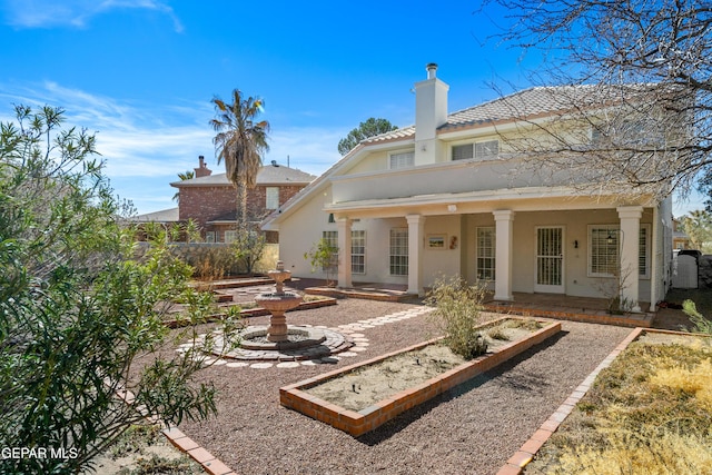 908 Via De La Paz Dr, El Paso, TX 79912 - back of house with stucco siding, a chimney, a patio, and a tiled roof