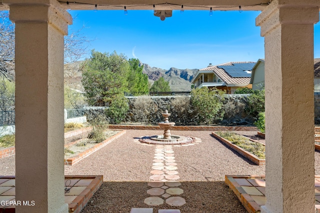 908 Via De La Paz Dr, El Paso, TX 79912 - fenced backyard with a vegetable garden and a mountain view