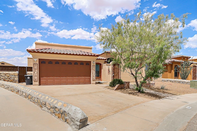 3841 Tierra Campa Dr, El Paso, TX 79938 - mediterranean / spanish home with stucco siding, a tiled roof, driveway, and a garage