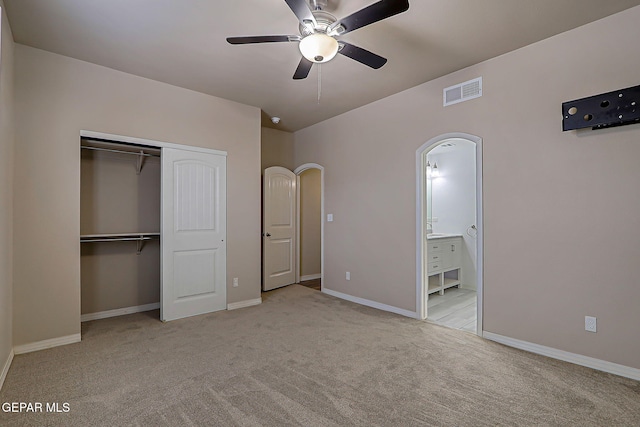 3841 Tierra Campa Dr, El Paso, TX 79938 - unfurnished bedroom with carpet, a closet, arched walkways, ensuite bath, and ceiling fan