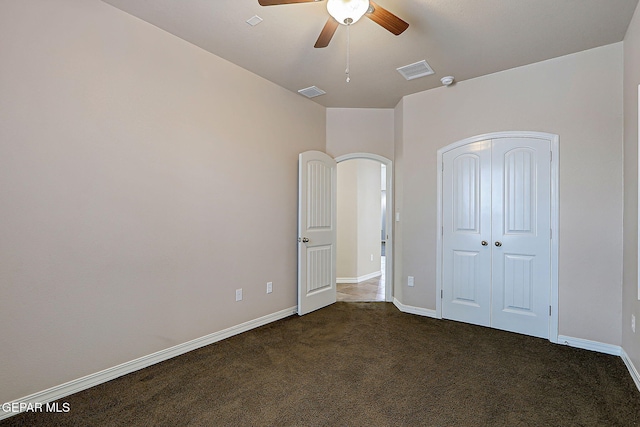 3841 Tierra Campa Dr, El Paso, TX 79938 - unfurnished bedroom featuring dark carpet, a closet, and a ceiling fan