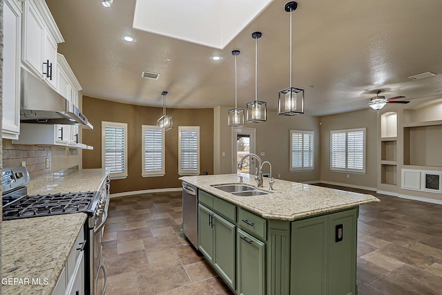 3841 Tierra Campa Dr, El Paso, TX 79938 - kitchen with green cabinetry, stainless steel appliances, under cabinet range hood, white cabinetry, and stone finish flooring