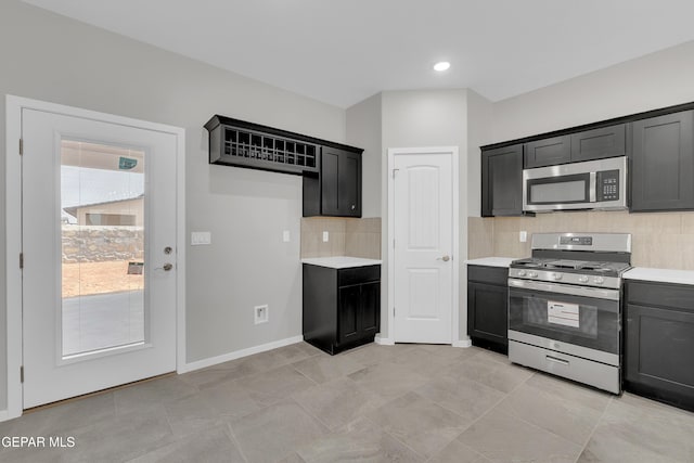 13845 Summer Wave Ave, El Paso, TX 79928 - kitchen featuring appliances with stainless steel finishes, light countertops, decorative backsplash, and dark cabinets