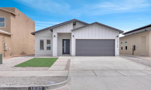 1445 Summer Storm Pl, El Paso, TX 79928 - view of front of property with a garage, board and batten siding, and driveway