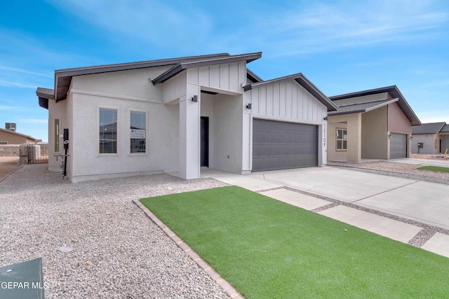 1445 Summer Storm Pl, El Paso, TX 79928 - view of front of property with driveway, an attached garage, and board and batten siding