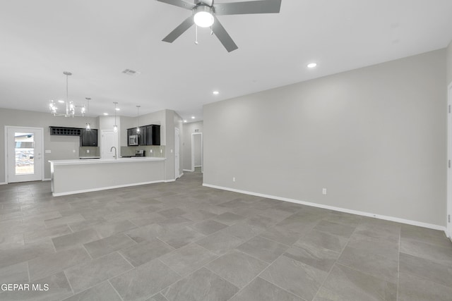 1445 Summer Storm Pl, El Paso, TX 79928 - unfurnished living room with a chandelier, a ceiling fan, recessed lighting, a sink, and baseboards