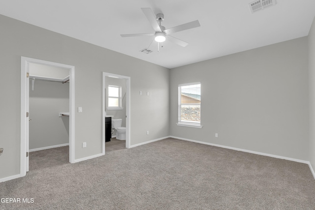1445 Summer Storm Pl, El Paso, TX 79928 - unfurnished bedroom with a walk in closet, carpet floors, and baseboards
