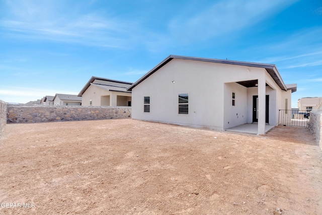 1445 Summer Storm Pl, El Paso, TX 79928 - back of property with a fenced backyard, stucco siding, and a patio area