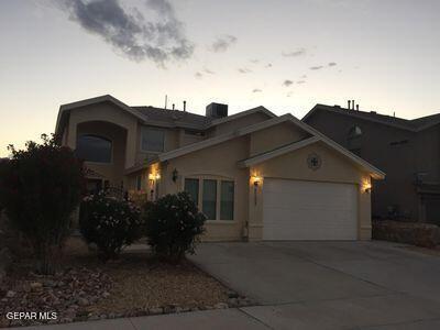 11353 W Ranch Ct NE, El Paso, TX 79934 - traditional-style house with driveway, a garage, and stucco siding