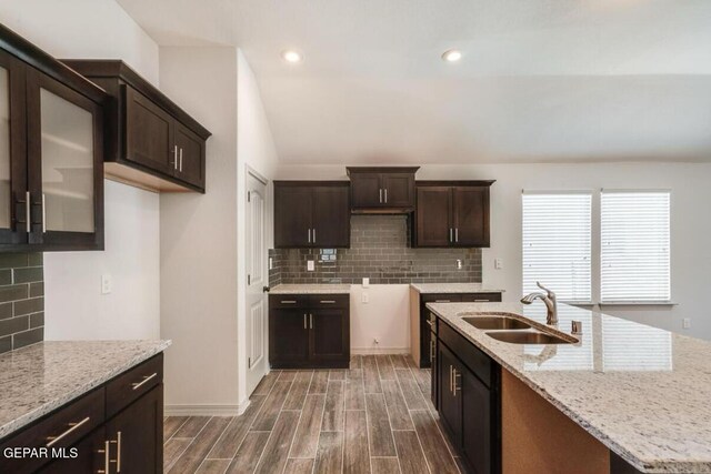 13833 Sky Harbor Ave, Horizon City, TX 79928 - kitchen with dark brown cabinets, decorative backsplash, light stone countertops, and recessed lighting