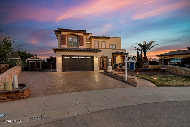 3081 Coyote Point Pl, El Paso, TX 79938 - mediterranean / spanish-style home featuring stucco siding, a tile roof, driveway, and an attached garage