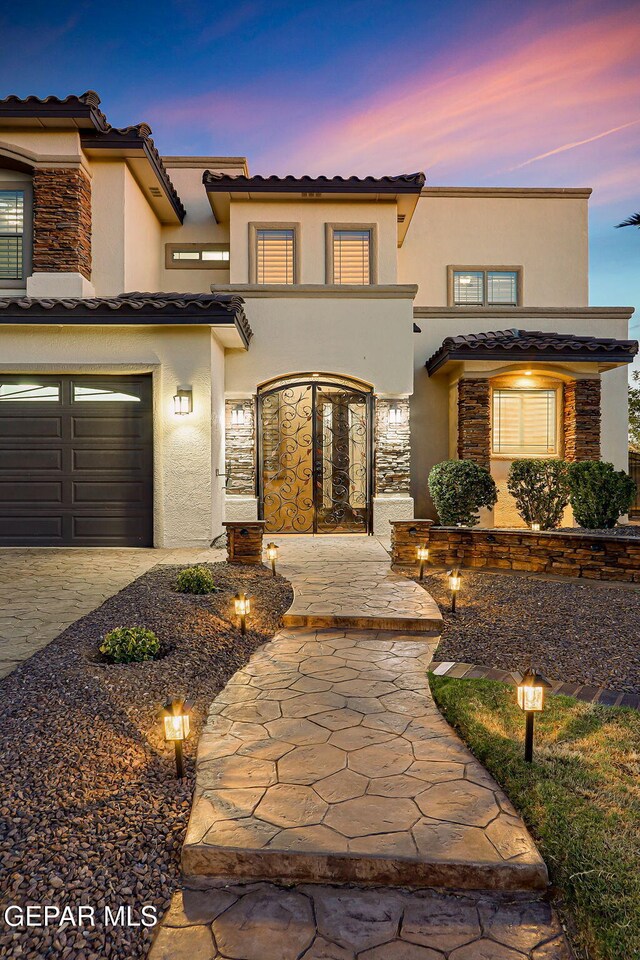 3081 Coyote Point Pl, El Paso, TX 79938 - view of front of property with stucco siding, a tile roof, a garage, and stone siding