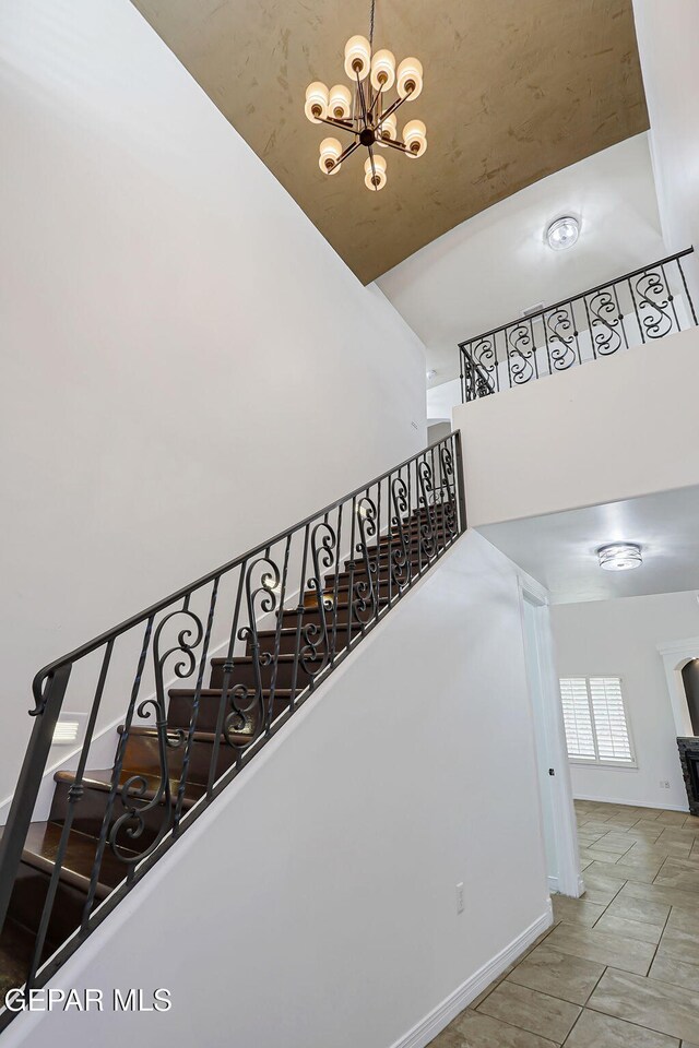 3081 Coyote Point Pl, El Paso, TX 79938 - staircase with a towering ceiling and a chandelier