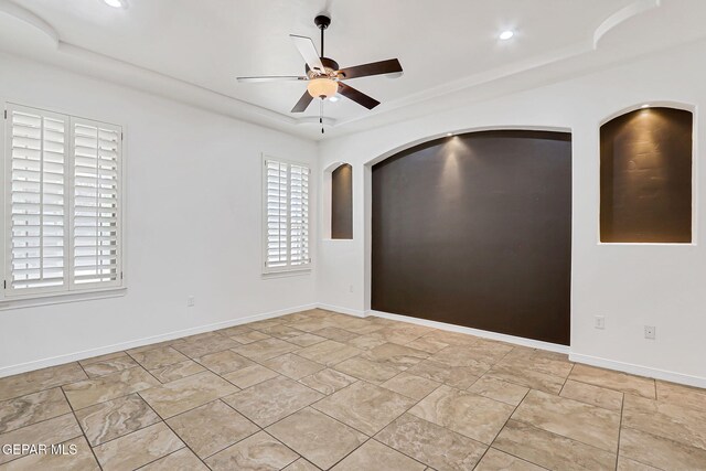 3081 Coyote Point Pl, El Paso, TX 79938 - unfurnished room featuring ceiling fan, a tray ceiling, arched walkways, and recessed lighting