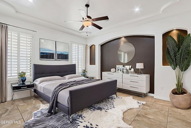 3081 Coyote Point Pl, El Paso, TX 79938 - bedroom featuring a raised ceiling, multiple windows, arched walkways, a ceiling fan, and recessed lighting