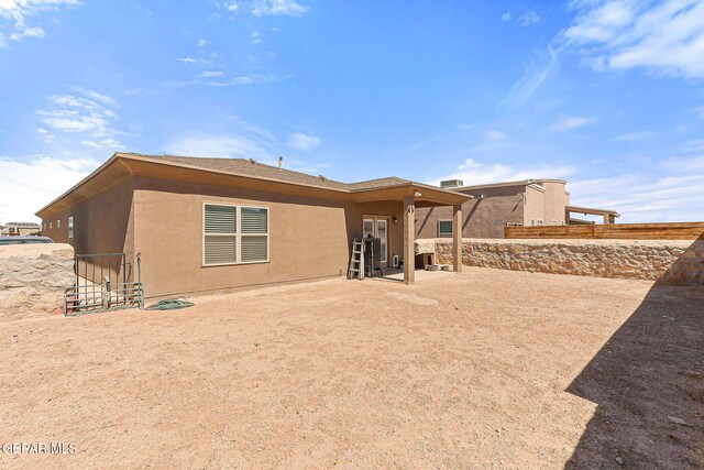 11589 Flor Cadillo, Socorro, TX 79927 - rear view of house with stucco siding and a patio area