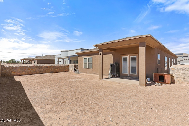 11589 Flor Cadillo, Socorro, TX 79927 - back of property with stucco siding and a patio