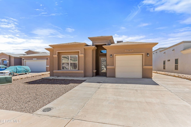 11589 Flor Cadillo, Socorro, TX 79927 - prairie-style house with driveway, an attached garage, and stucco siding