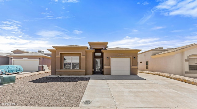 11589 Flor Cadillo, Socorro, TX 79927 - prairie-style home with driveway, an attached garage, and stucco siding
