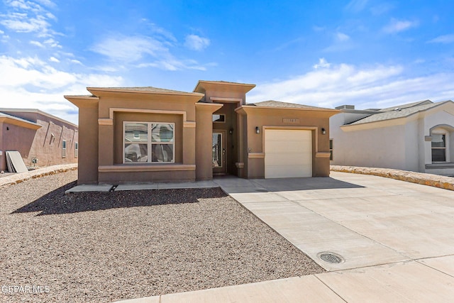 11589 Flor Cadillo, Socorro, TX 79927 - prairie-style house featuring concrete driveway, a garage, and stucco siding