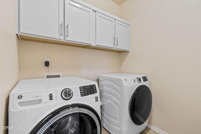 11589 Flor Cadillo, Socorro, TX 79927 - laundry area with cabinet space, washer and dryer, and baseboards