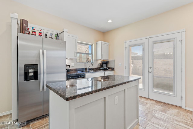 11589 Flor Cadillo, Socorro, TX 79927 - kitchen featuring appliances with stainless steel finishes, a sink, white cabinetry, dark stone counters, and french doors